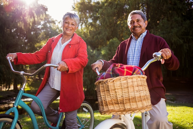 Smiling mature couple with bicycle