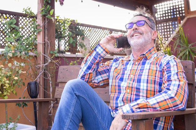 Smiling mature man talking on mobile