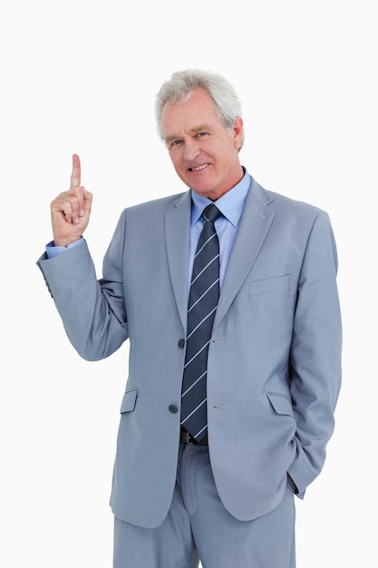 Smiling mature tradesman pointing up