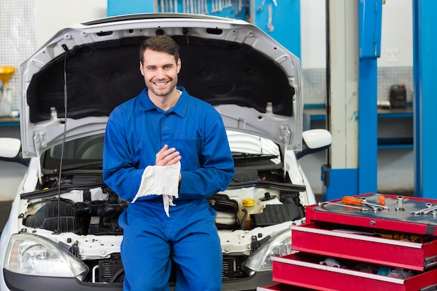 Smiling mechanic looking at camera