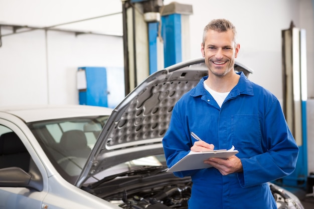 Smiling mechanic looking at camera