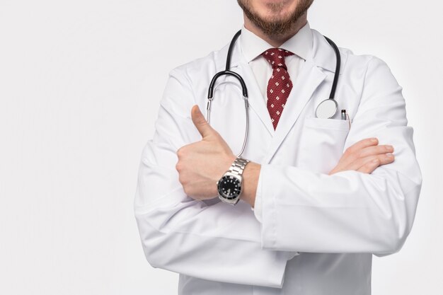 Smiling medical doctor. Isolated over white wall