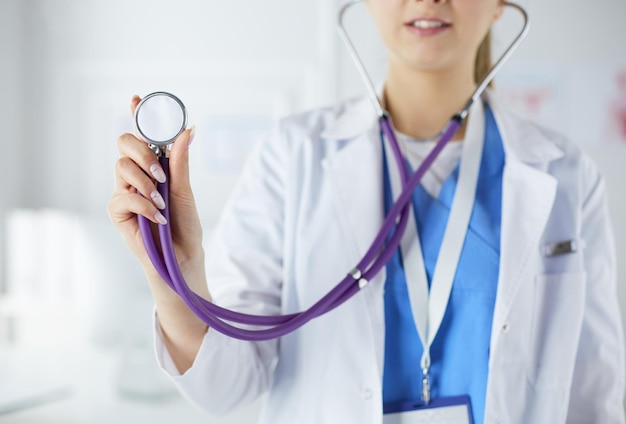 Smiling medical doctor woman with stethoscope in hospital