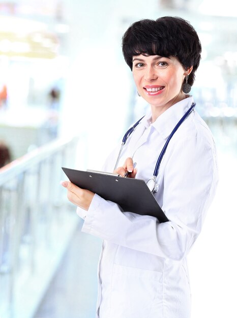 Smiling medical doctor woman with stethoscope.