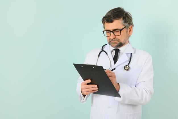 Smiling medical senior doctor with a stethoscope On a blue background The concept of humanity's victory over disease