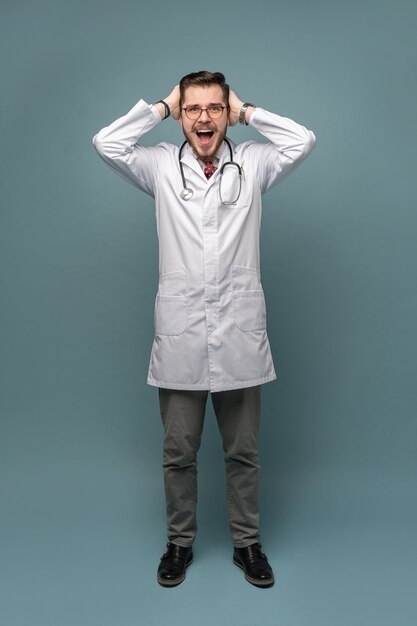 Smiling medical worker in white coat and tie