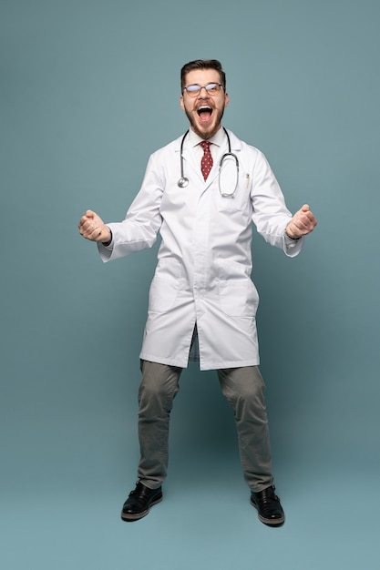 Smiling medical worker in white coat and tie