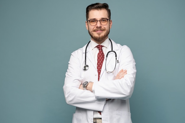 Smiling medical worker in white coat and tie