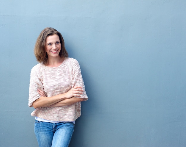 Smiling mid adult woman standing with arms crossed 