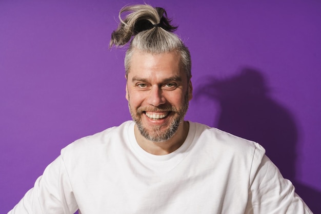 Smiling middle aged man against purple background