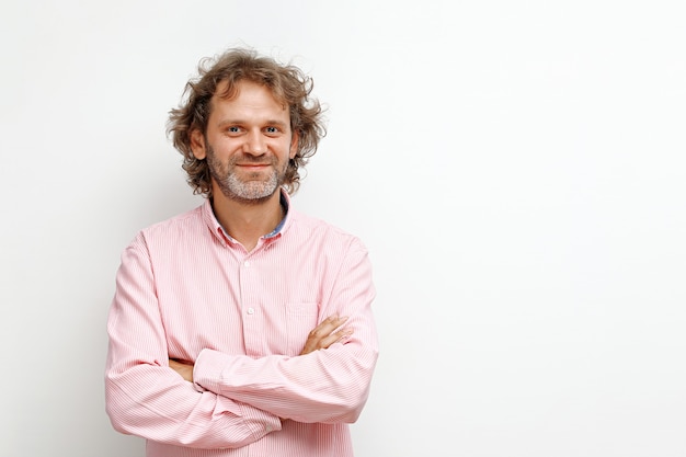 Smiling middleaged man with curly hair on a white background