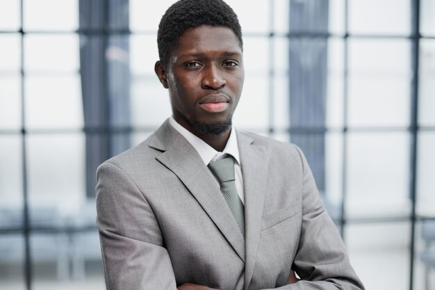 Smiling millennial confident black guy posing for photo looking at camera