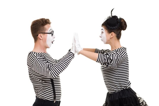 Smiling mimes in striped shirts