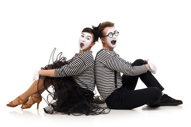 Smiling mimes in striped shirts