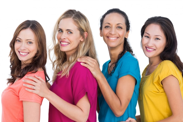 Smiling models posing with colorful t shirts