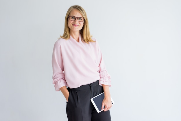 Smiling modern business lady with tablet wearing stylish clothes and eyeglasses 