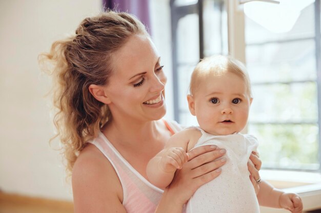 Smiling mother holding her baby