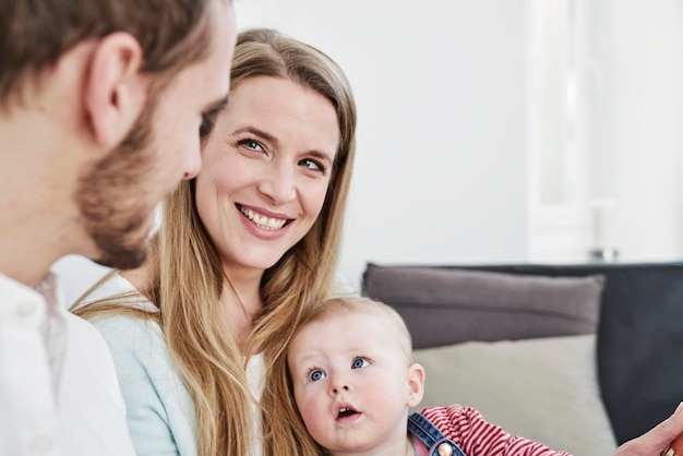 Smiling mother with father and daughter at home