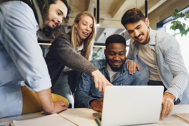 Photo smiling multiracial coworkers working together at office meeting have a discussion