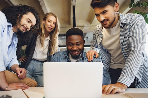 Smiling multiracial coworkers working together at office meeting have a discussion