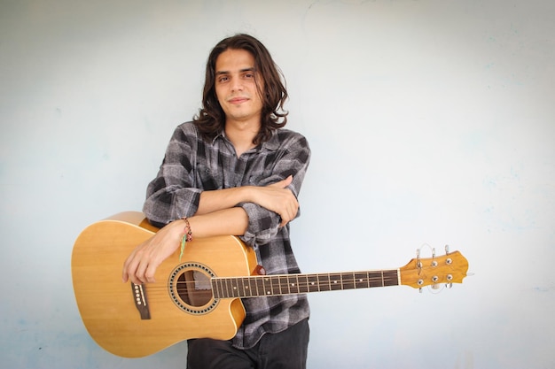 A smiling musician with guitar