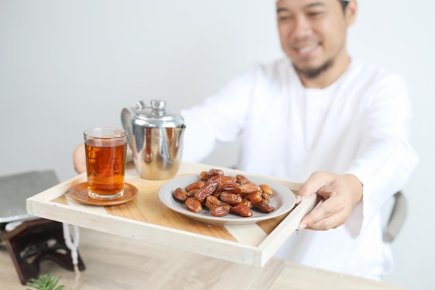 Smiling Muslim Man Giving Iftar Food and Drinks For Breakfasting on Ramadan Month