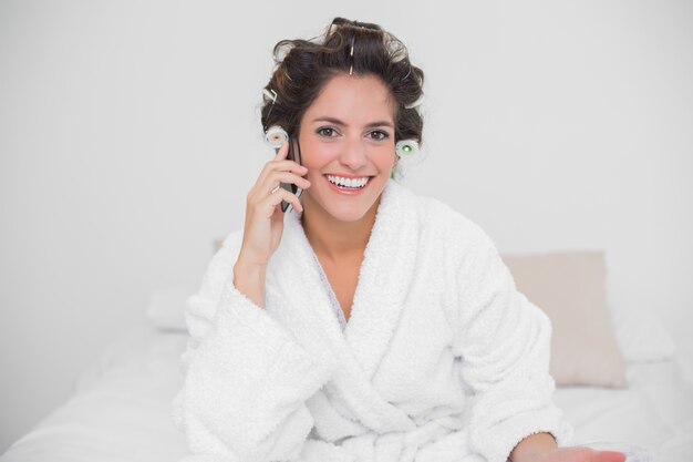 Smiling natural brunette phoning