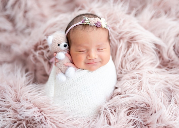 Smiling newborn in diadem