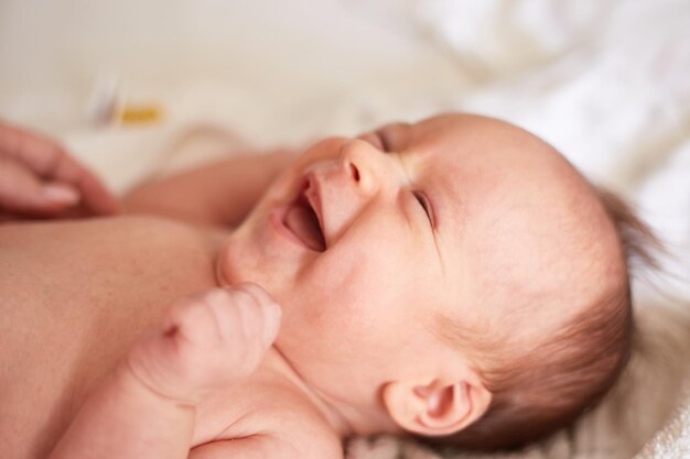 Smiling newborn one month old baby boy smiling baby