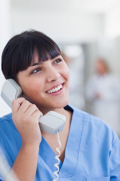 Smiling nurse holding a phone