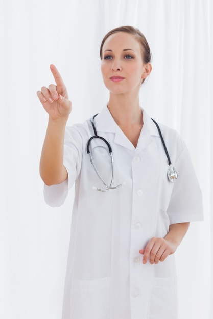 Smiling nurse pointing at something