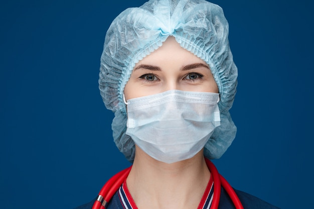 Smiling paramedic in hat and mask. COVID-19.