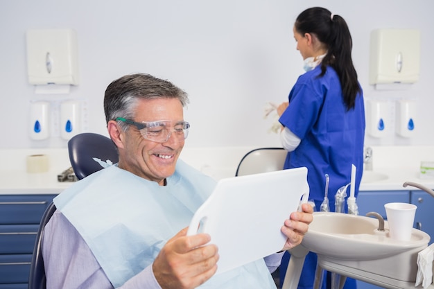 Smiling patient holding a mirror