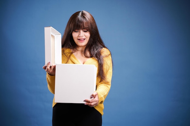 smiling pretty girl holding a package friendly