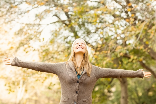 Smiling pretty woman with arms outstretched