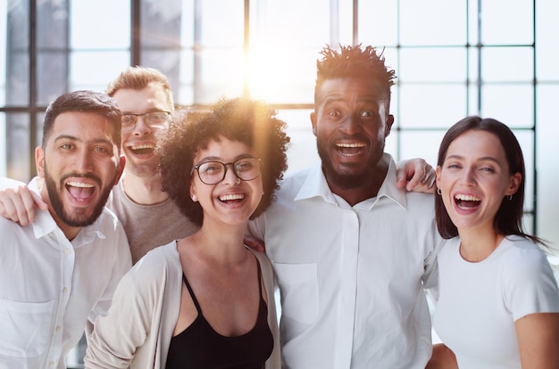 Smiling professional business leaders and employees group team portrait