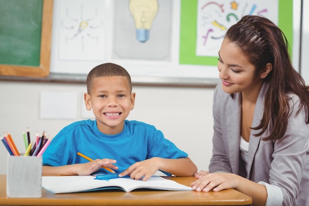 Smiling pupil being helped by teacher