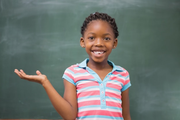 Smiling pupil raising her hand 