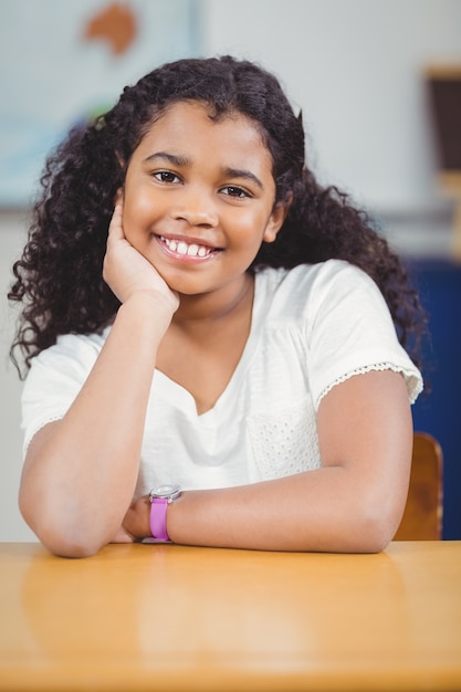 Smiling pupil sitting in a classroom