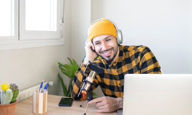 Smiling radio host sitting in office with microphone