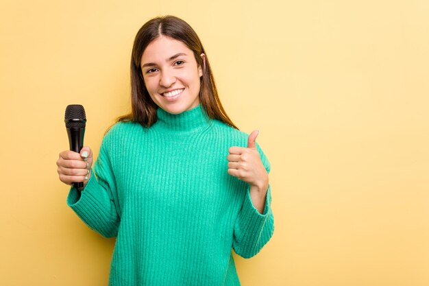 Smiling and raising thumb up