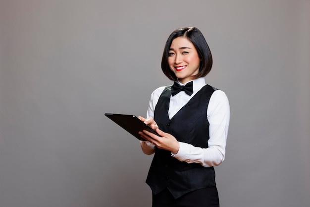 Smiling receptionist using tablet