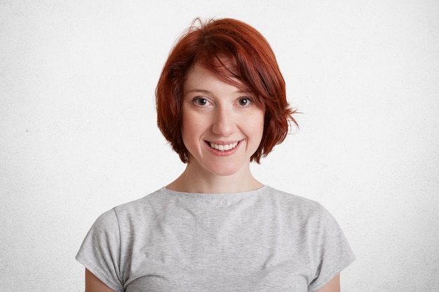 Smiling redhaired female with short hair