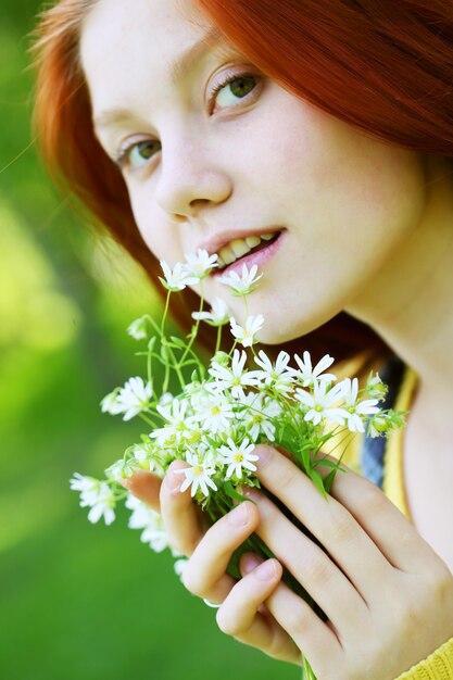 Ragazza dai capelli rossi sorridente, all'aperto