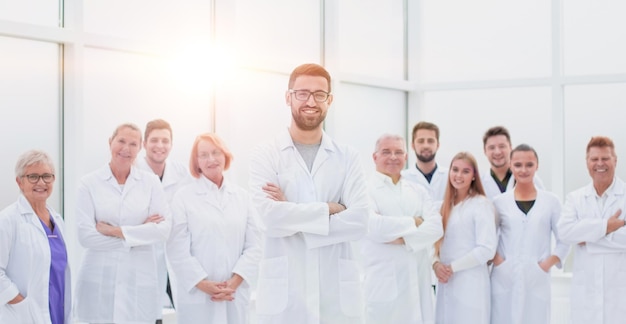 Smiling research supervisor standing in front of his team