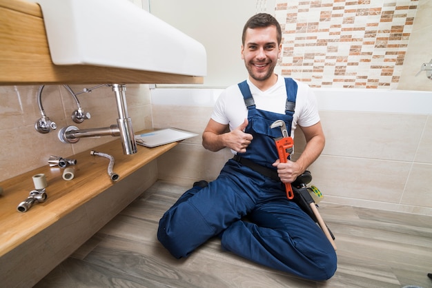 Smiling sanitary technician gesturing thumb up