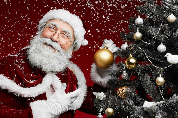 Smiling Santa Claus by Christmas Tree