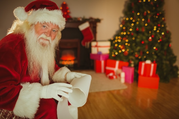 Smiling santa claus holding a scroll