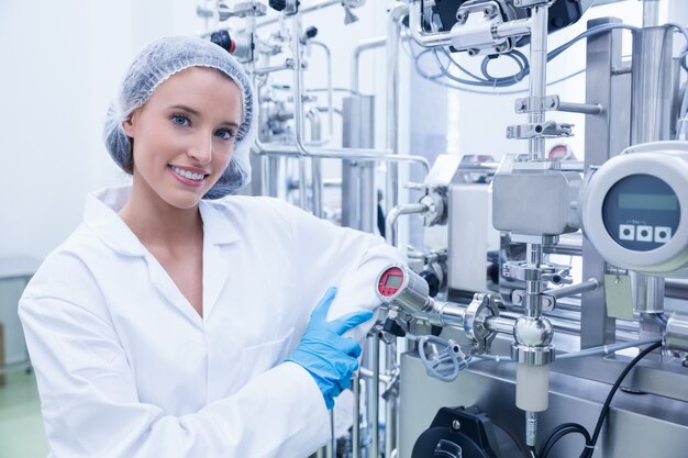 Smiling scientist leaning against gauge