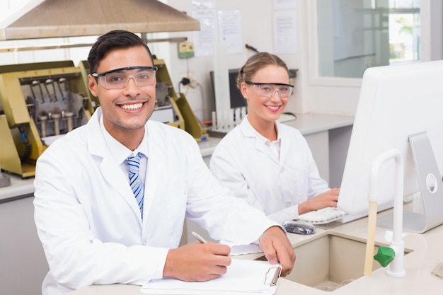 Smiling scientists looking at camera 